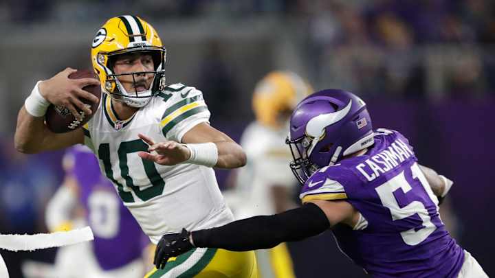 Green Bay Packers quarterback Jordan Love (10) is tackled by Minnesota Vikings linebacker Blake Cashman